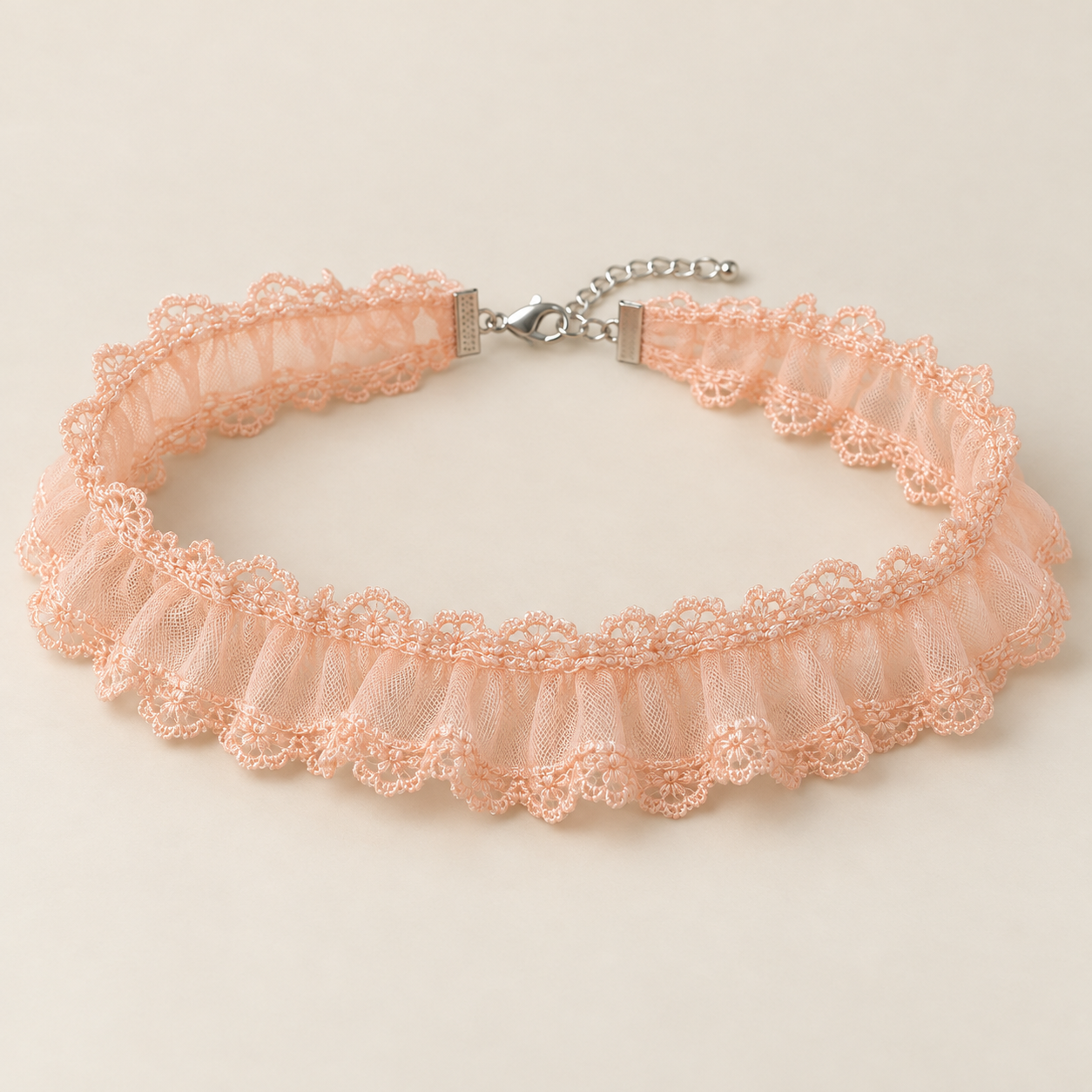 Peach Frill, pale peach polyester tulle with ruffled lace edging